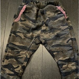 2 pairs of kids boutique pants.A camo pair with pink on pockets and blue velvet.
